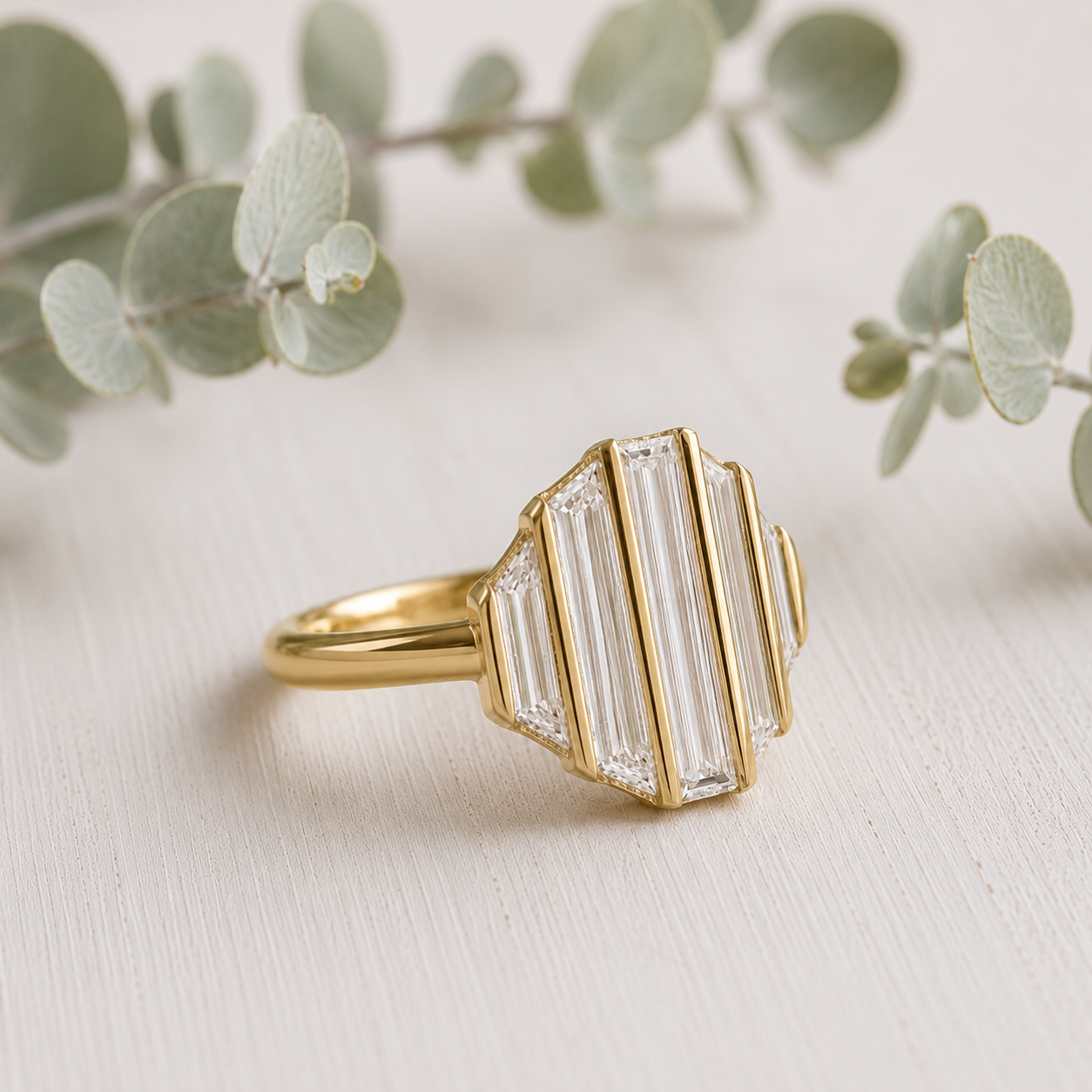Baguette Diamond Engagement Ring featuring a lab-grown baguette cut diamond center stone with trapeze cut side diamonds in a geometric contemporary gold setting with a slim 1.7 mm band, designed as a modern minimalist engagement ring.