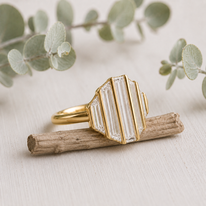 Baguette Diamond Engagement Ring featuring a lab-grown baguette cut diamond center stone with trapeze cut side diamonds in a geometric contemporary gold setting with a slim 1.7 mm band, designed as a modern minimalist engagement ring.