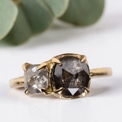Cushion rose cut salt and pepper diamond two stone ring featuring a 1.80 CT center diamond and 0.65 CT companion diamond with natural inclusions, handcrafted on a minimalist straight band alternative engagement design.