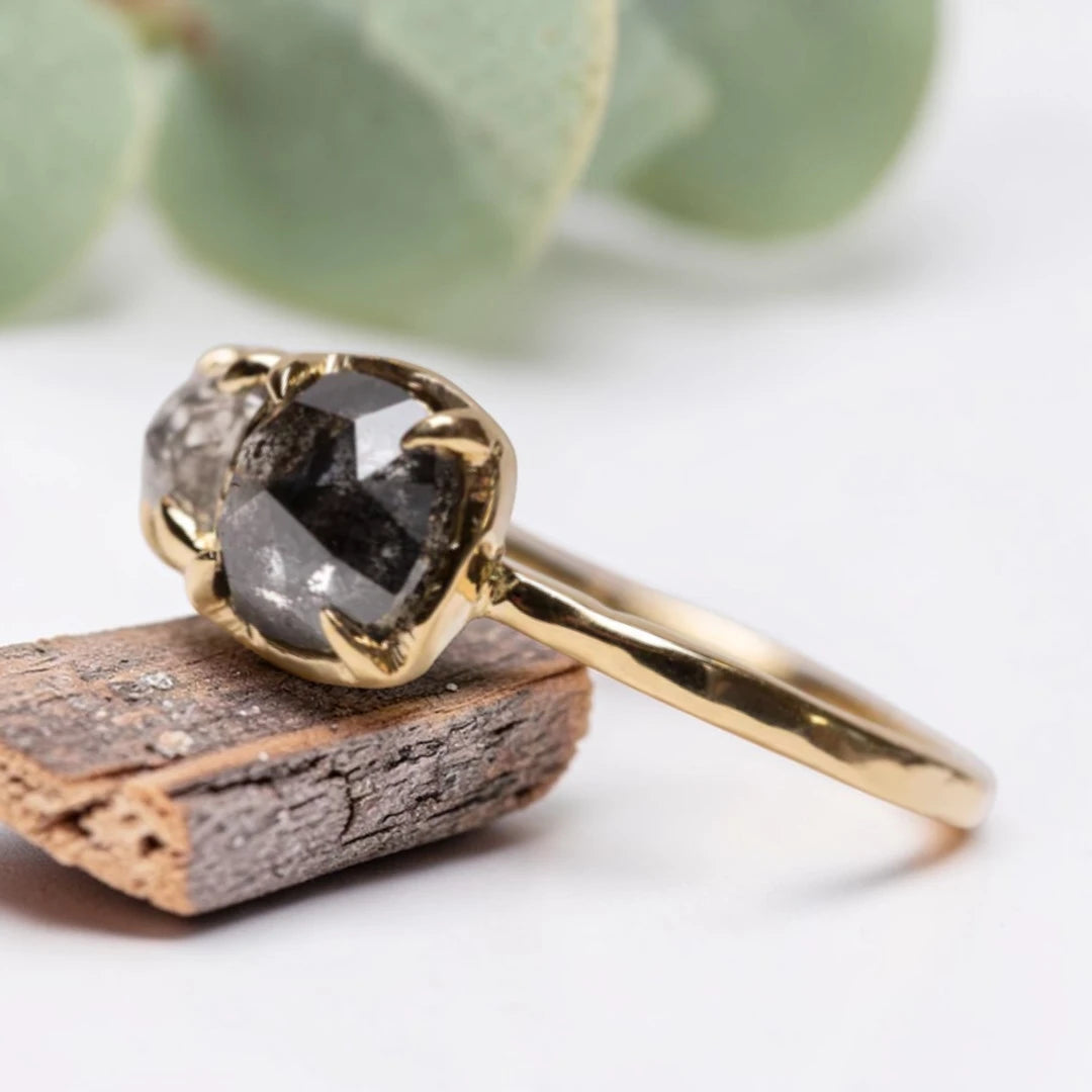 Cushion rose cut salt and pepper diamond two stone ring featuring a 1.80 CT center diamond and 0.65 CT companion diamond with natural inclusions, handcrafted on a minimalist straight band alternative engagement design.