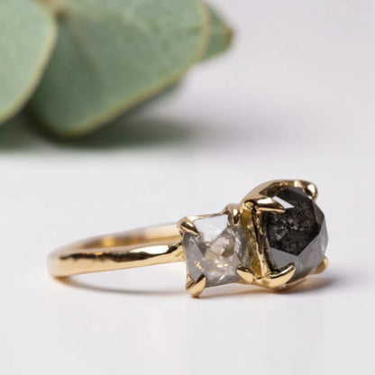 Cushion rose cut salt and pepper diamond two stone ring featuring a 1.80 CT center diamond and 0.65 CT companion diamond with natural inclusions, handcrafted on a minimalist straight band alternative engagement design.