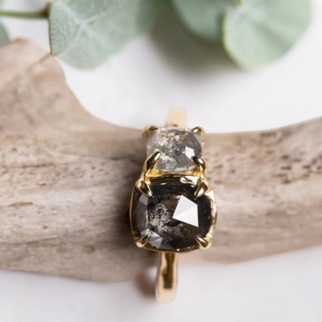 Cushion rose cut salt and pepper diamond two stone ring featuring a 1.80 CT center diamond and 0.65 CT companion diamond with natural inclusions, handcrafted on a minimalist straight band alternative engagement design.