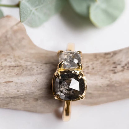 Cushion rose cut salt and pepper diamond two stone ring featuring a 1.80 CT center diamond and 0.65 CT companion diamond with natural inclusions, handcrafted on a minimalist straight band alternative engagement design.