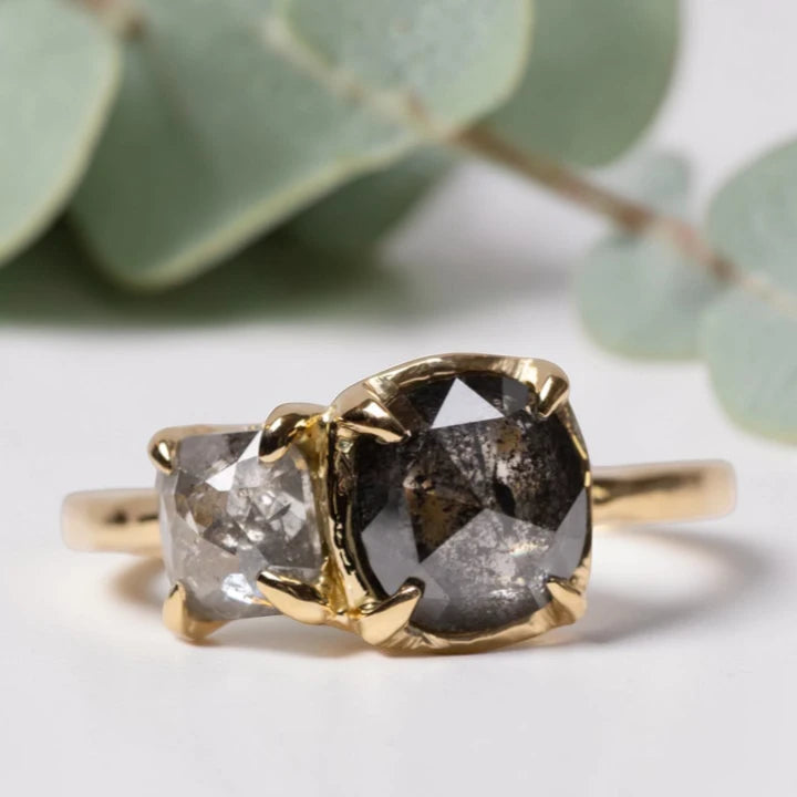 Cushion rose cut salt and pepper diamond two stone ring featuring a 1.80 CT center diamond and 0.65 CT companion diamond with natural inclusions, handcrafted on a minimalist straight band alternative engagement design.
