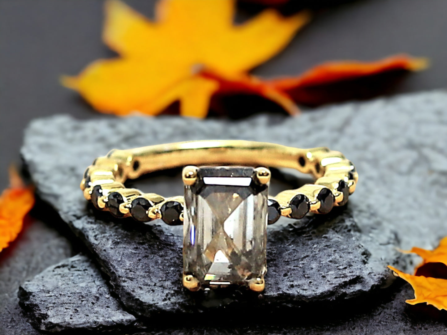 Emerald Cut Salt and Pepper Diamond Ring featuring a 2.58 CT natural salt and pepper diamond with speckled galaxy-like inclusions in a minimalist bezel setting, accented by 16 round brilliant diamonds in a straight 1.80 mm band for a modern geometric design.