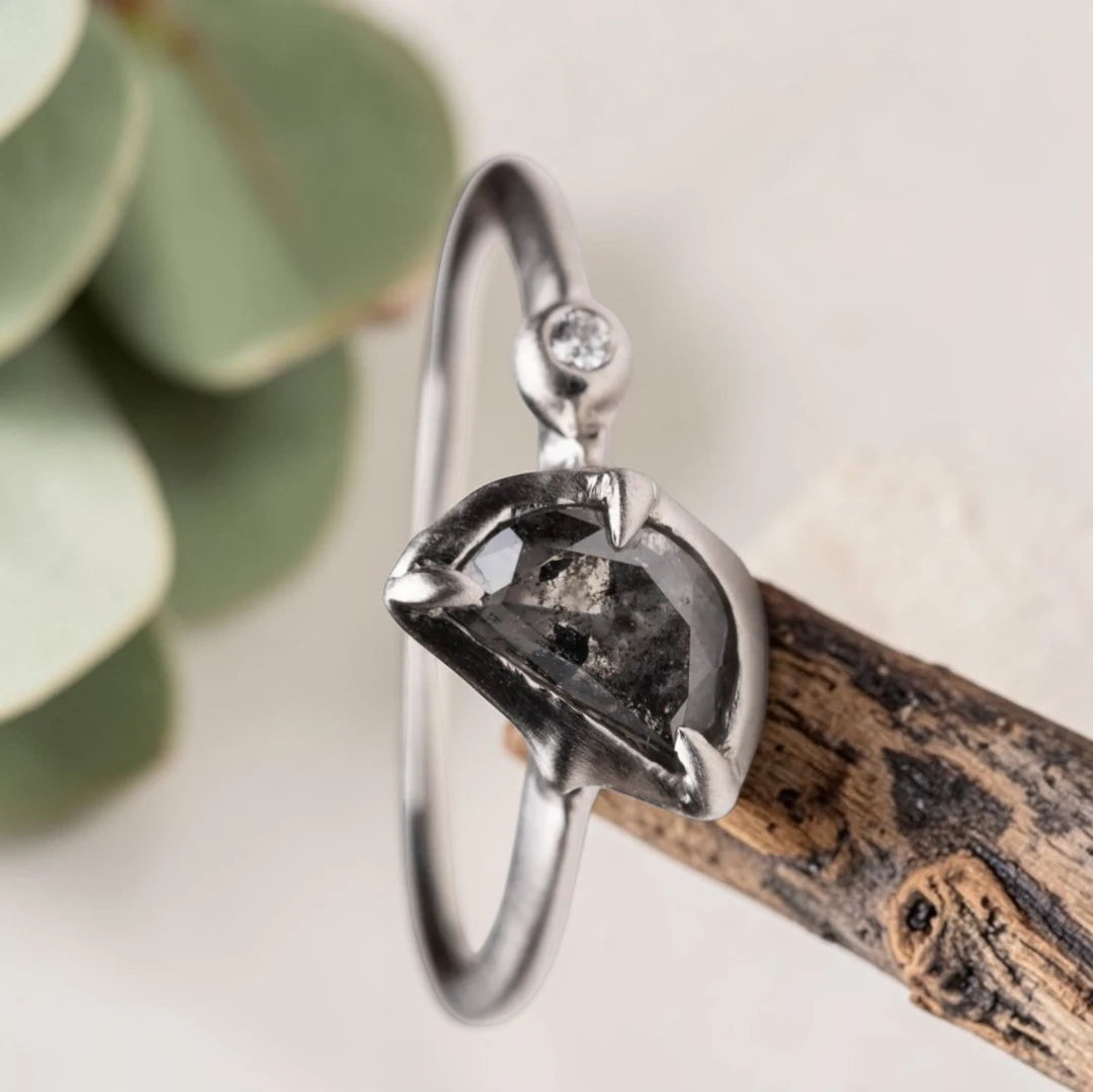 Half moon rose cut salt and pepper diamond statement engagement ring featuring a 1.35 CT natural center stone with galaxy-like inclusions and 1.00 CT round diamond accents on a handcrafted reverse tapered band.