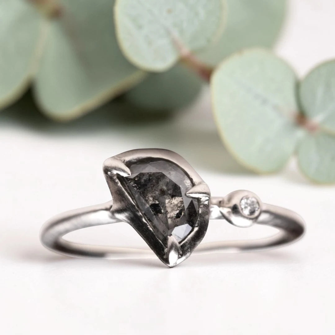 Half moon rose cut salt and pepper diamond statement engagement ring featuring a 1.35 CT natural center stone with galaxy-like inclusions and 1.00 CT round diamond accents on a handcrafted reverse tapered band.