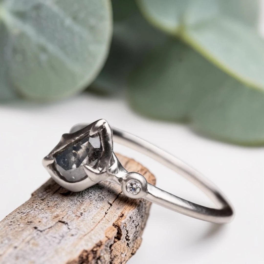Half moon rose cut salt and pepper diamond statement engagement ring featuring a 1.35 CT natural center stone with galaxy-like inclusions and 1.00 CT round diamond accents on a handcrafted reverse tapered band.