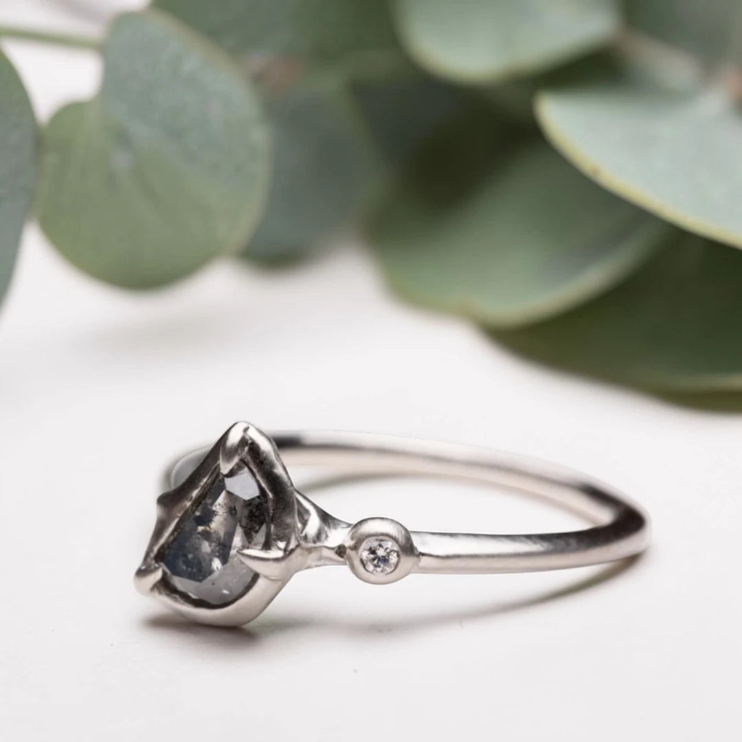 Half moon rose cut salt and pepper diamond statement engagement ring featuring a 1.35 CT natural center stone with galaxy-like inclusions and 1.00 CT round diamond accents on a handcrafted reverse tapered band.