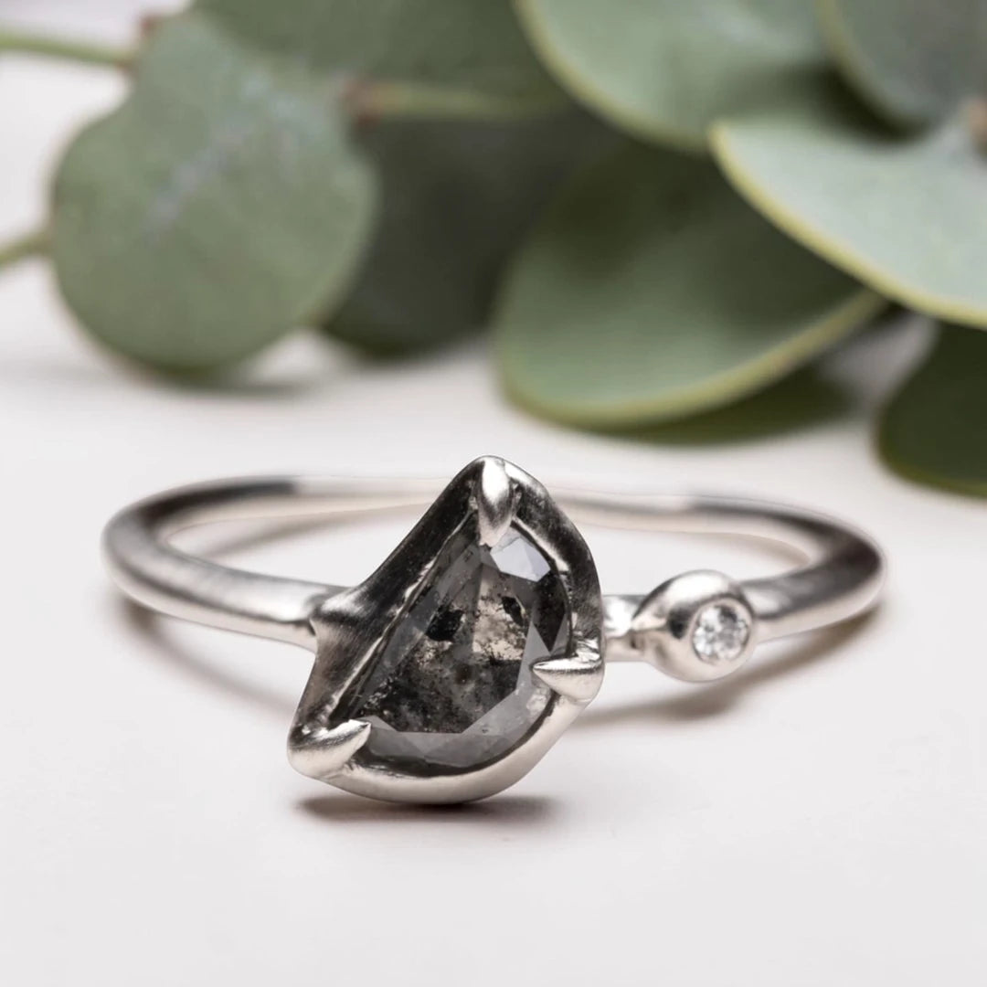 Half moon rose cut salt and pepper diamond statement engagement ring featuring a 1.35 CT natural center stone with galaxy-like inclusions and 1.00 CT round diamond accents on a handcrafted reverse tapered band.