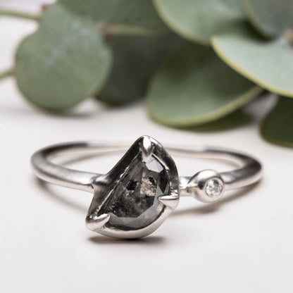 Half moon rose cut salt and pepper diamond statement engagement ring featuring a 1.35 CT natural center stone with galaxy-like inclusions and 1.00 CT round diamond accents on a handcrafted reverse tapered band.
