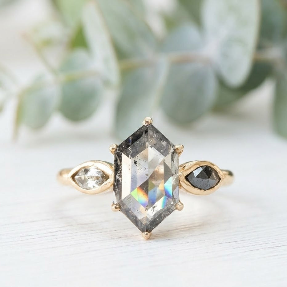 Hexagon Cut Salt and Pepper Diamond Ring featuring a 2.12 CT natural salt and pepper hexagon diamond with organic inclusions, accented by two pear cut salt and pepper diamonds in a minimalist geometric engagement design with a straight 1.6 mm band and handcrafted fine jewelry aesthetic.