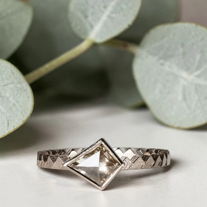 Kite cut salt and pepper diamond ring featuring a 0.55 CT natural diamond with unique inclusions, set on a straight band with zig zag engraved detailing in a handcrafted minimalist alternative engagement ring design.