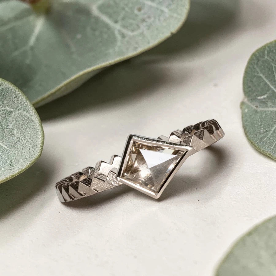 Kite cut salt and pepper diamond ring featuring a 0.55 CT natural diamond with unique inclusions, set on a straight band with zig zag engraved detailing in a handcrafted minimalist alternative engagement ring design.