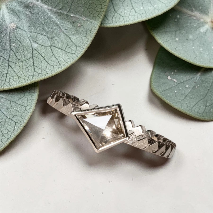 Kite cut salt and pepper diamond ring featuring a 0.55 CT natural diamond with unique inclusions, set on a straight band with zig zag engraved detailing in a handcrafted minimalist alternative engagement ring design.