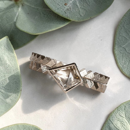 Kite cut salt and pepper diamond ring featuring a 0.55 CT natural diamond with unique inclusions, set on a straight band with zig zag engraved detailing in a handcrafted minimalist alternative engagement ring design.