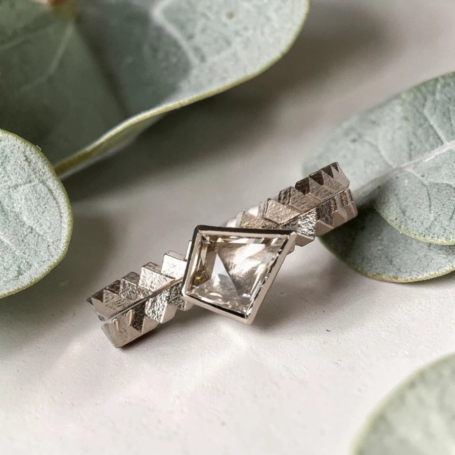 Kite cut salt and pepper diamond ring featuring a 0.55 CT natural diamond with unique inclusions, set on a straight band with zig zag engraved detailing in a handcrafted minimalist alternative engagement ring design.