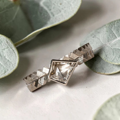Kite cut salt and pepper diamond ring featuring a 0.55 CT natural diamond with unique inclusions, set on a straight band with zig zag engraved detailing in a handcrafted minimalist alternative engagement ring design.