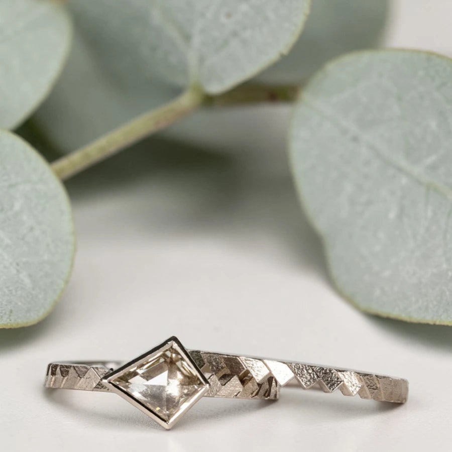 Kite cut salt and pepper diamond ring featuring a 0.55 CT natural diamond with unique inclusions, set on a straight band with zig zag engraved detailing in a handcrafted minimalist alternative engagement ring design.