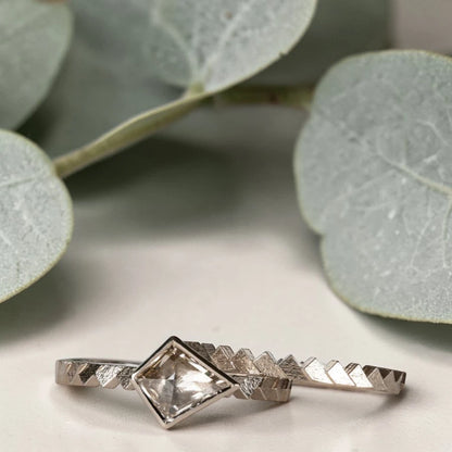 Kite cut salt and pepper diamond ring featuring a 0.55 CT natural diamond with unique inclusions, set on a straight band with zig zag engraved detailing in a handcrafted minimalist alternative engagement ring design.