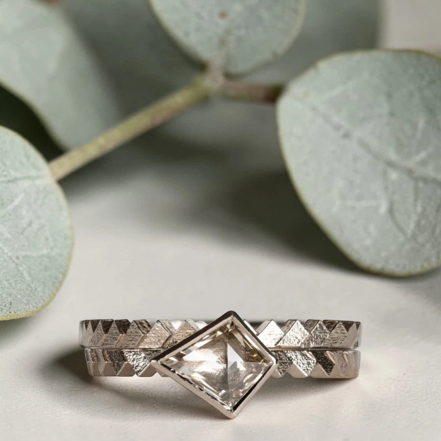 Kite cut salt and pepper diamond ring featuring a 0.55 CT natural diamond with unique inclusions, set on a straight band with zig zag engraved detailing in a handcrafted minimalist alternative engagement ring design.