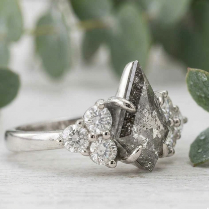 Natural Salt and Pepper Diamond Ring featuring a 1.68 CT round rose cut center stone with organic inclusions, accented by lab-grown round diamonds in a four-stone symmetrical arrangement with a straight shank and 1.80 mm band, designed as a vintage-inspired engagement ring.
