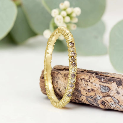 Organic Wide Band Salt and Pepper Diamond Ring featuring a 0.60 CT natural round center diamond with cognac champagne and black tones, surrounded by 27 salt and pepper diamonds in a handmade minimalist wide band design with organic aesthetic.