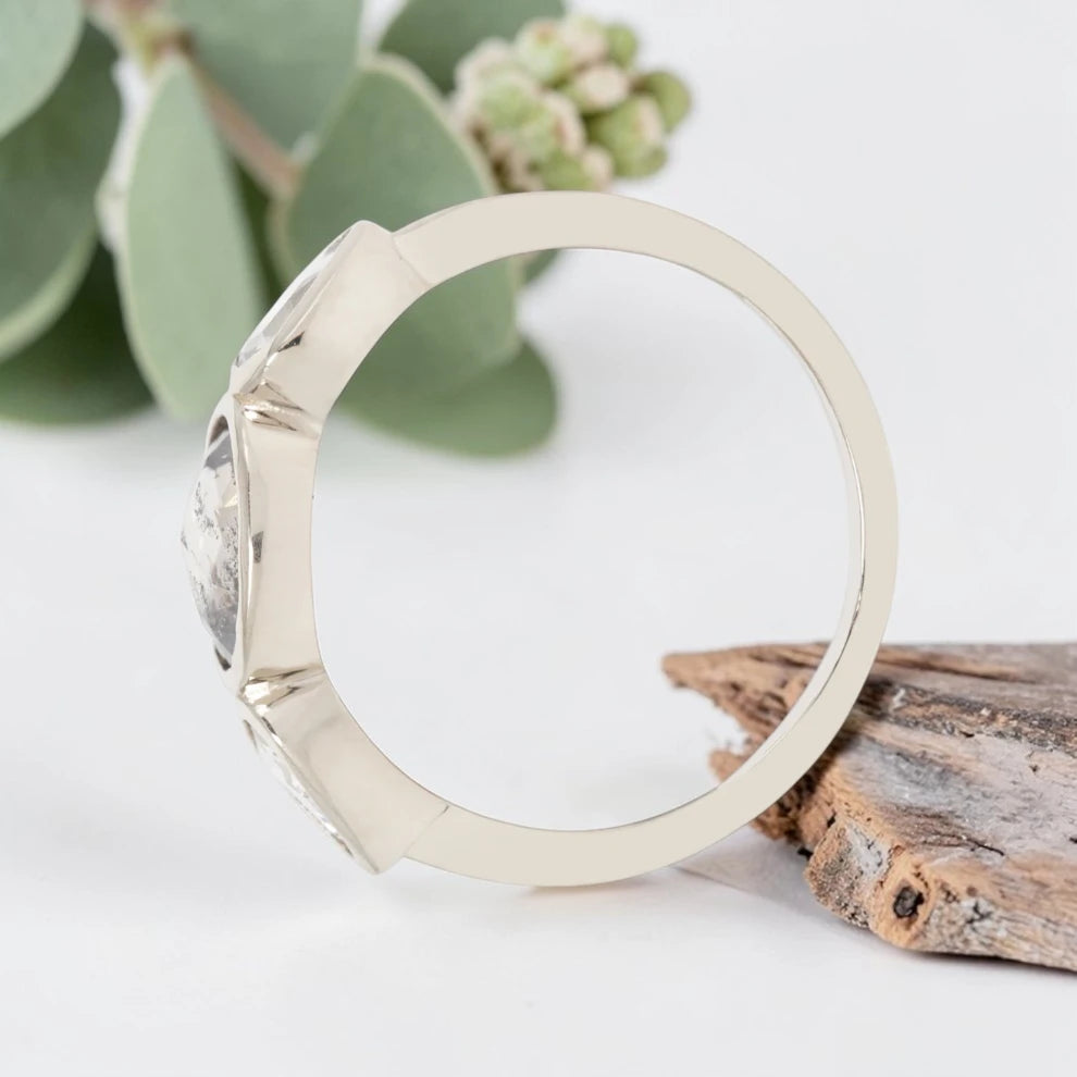 Oval cut salt and pepper diamond engagement ring featuring a 2.50 CT natural center stone with pear shaped side diamonds, set on a handcrafted knife edge band in a modern vintage fusion design.