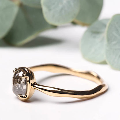 Oval Rose Cut Salt and Pepper Diamond Ring featuring a 0.90 CT natural salt and pepper diamond with organic inclusions in a classic prong setting and handcrafted minimalist design with a reverse tapered 1.80 mm band suitable for engagement and everyday wear.