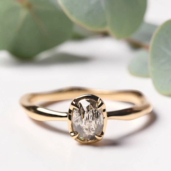 Oval Rose Cut Salt and Pepper Diamond Ring featuring a 0.90 CT natural salt and pepper diamond with organic inclusions in a classic prong setting and handcrafted minimalist design with a reverse tapered 1.80 mm band suitable for engagement and everyday wear.