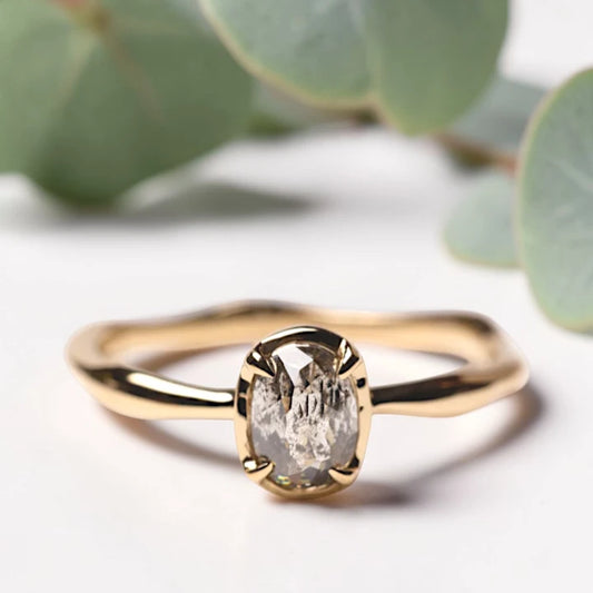 Oval Rose Cut Salt and Pepper Diamond Ring featuring a 0.90 CT natural salt and pepper diamond with organic inclusions in a classic prong setting and handcrafted minimalist design with a reverse tapered 1.80 mm band suitable for engagement and everyday wear.
