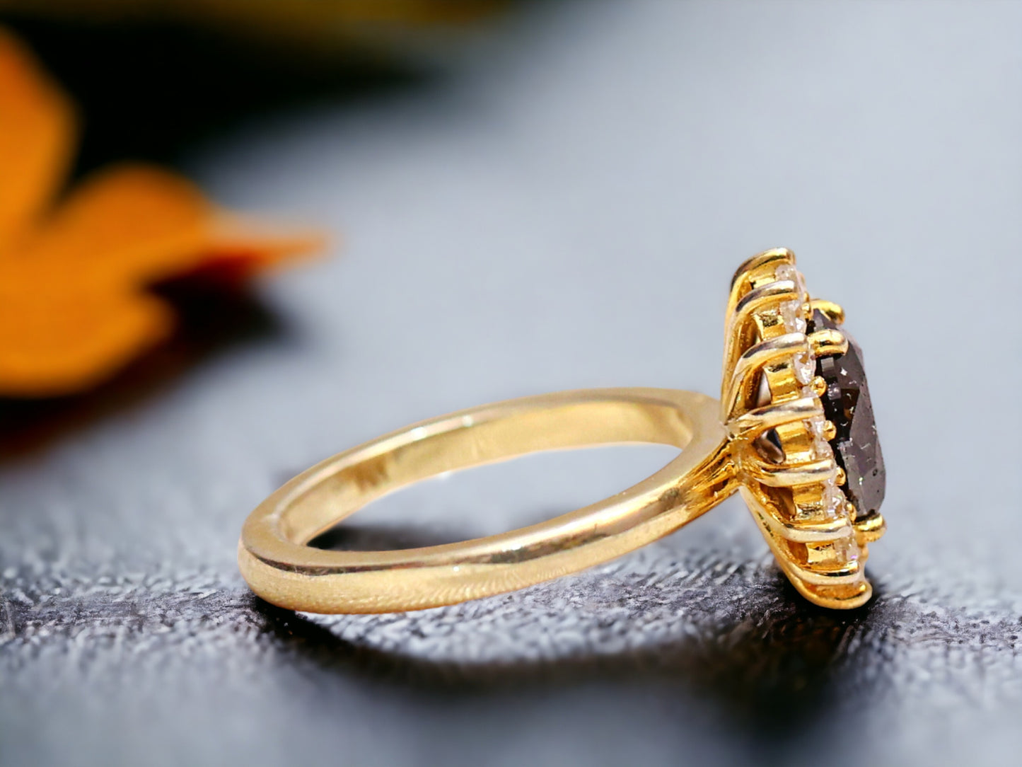 Oval Salt and Pepper Diamond Ring featuring a 2.10 CT natural salt and pepper diamond with galaxy-like inclusions, accented by round brilliant diamonds in a handcrafted bezel setting with a reverse tapered 2.50 mm band, designed as a minimalist statement engagement ring.