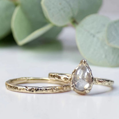 Pear Cut Salt and Pepper Diamond Ring featuring a 0.95 CT natural salt and pepper diamond with unique organic inclusions in a rustic bezel-inspired setting, crafted in a handcrafted vintage-inspired fine jewelry design with a straight 1.90 mm band for alternative bridal styling.