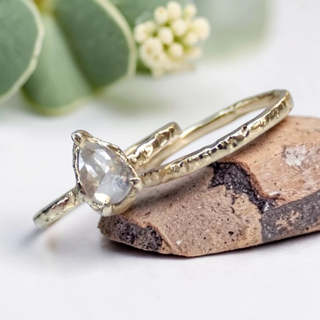 Pear Cut Salt and Pepper Diamond Ring featuring a 0.95 CT natural salt and pepper diamond with unique organic inclusions in a rustic bezel-inspired setting, crafted in a handcrafted vintage-inspired fine jewelry design with a straight 1.90 mm band for alternative bridal styling.