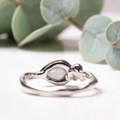 Pear Rose Cut Salt and Pepper Diamond Ring featuring a 1.50 CT natural salt and pepper diamond with organic inclusions, accented by two round cut diamond side stones in a handcrafted three stone design with a reverse tapered band and vintage inspired bridal elegance.