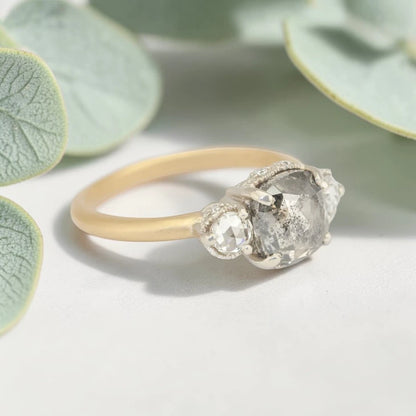 Rose cushion cut salt and pepper diamond vintage engagement ring featuring a 1.70 CT natural center diamond with galaxy-like inclusions and 0.35 CT round rose cut side diamonds on a handcrafted straight band design.