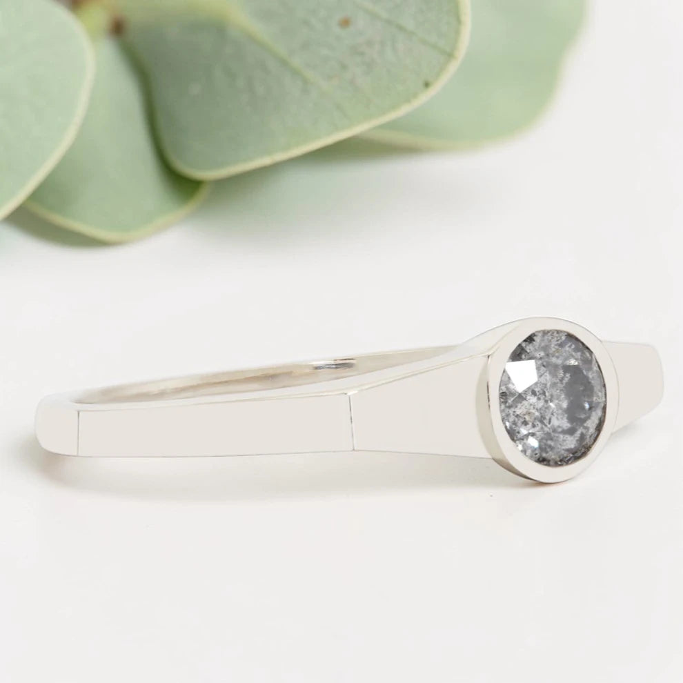 Round Cut Salt and Pepper Diamond Ring featuring a 0.27 CT natural salt and pepper diamond with organic inclusions in a minimalist handmade design with a reverse tapered 2.65 mm band and modern fine jewelry aesthetic.