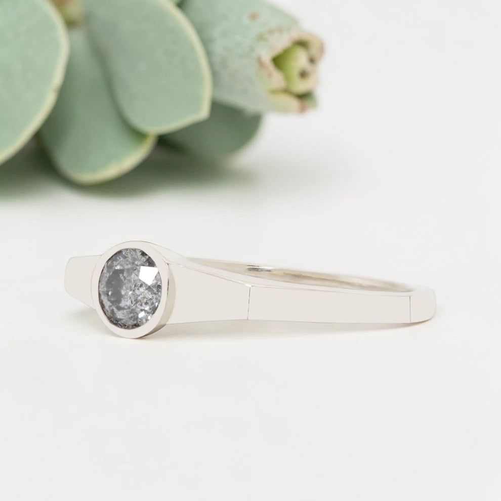 Round Cut Salt and Pepper Diamond Ring featuring a 0.27 CT natural salt and pepper diamond with organic inclusions in a minimalist handmade design with a reverse tapered 2.65 mm band and modern fine jewelry aesthetic.