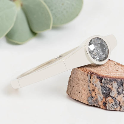 Round Cut Salt and Pepper Diamond Ring featuring a 0.27 CT natural salt and pepper diamond with organic inclusions in a minimalist handmade design with a reverse tapered 2.65 mm band and modern fine jewelry aesthetic.