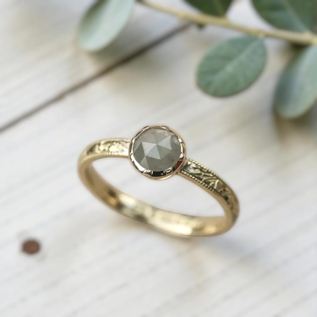 Round diamond ring inspired by ethical natural diamond beauty featuring a minimalist handcrafted design with a natural round diamond center stone and refined fine jewelry aesthetic suitable for engagement and everyday wear.