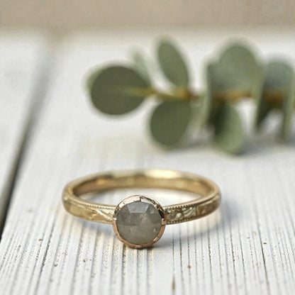 Round diamond ring inspired by ethical natural diamond beauty featuring a minimalist handcrafted design with a natural round diamond center stone and refined fine jewelry aesthetic suitable for engagement and everyday wear.