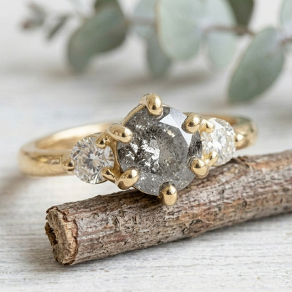 Round Salt and Pepper Diamond Engagement Ring featuring a 1.00 CT natural salt and pepper diamond with organic inclusions, accented by round brilliant side diamonds in a minimalist straight shank design with a 1.80 mm band in fine gold.