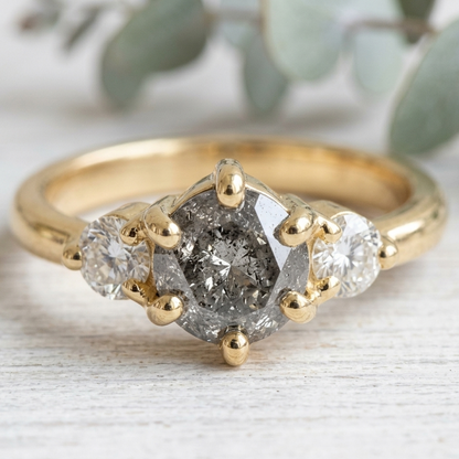 Round Salt and Pepper Diamond Engagement Ring featuring a 1.00 CT natural salt and pepper diamond with organic inclusions, accented by round brilliant side diamonds in a minimalist straight shank design with a 1.80 mm band in fine gold.
