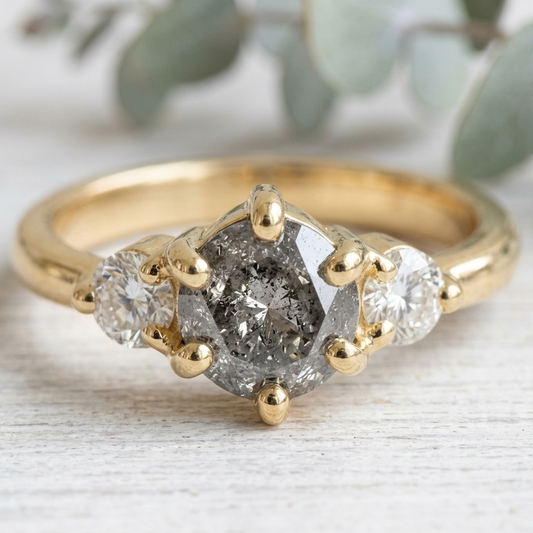 Round Salt and Pepper Diamond Engagement Ring featuring a 1.00 CT natural salt and pepper diamond with organic inclusions, accented by round brilliant side diamonds in a minimalist straight shank design with a 1.80 mm band in fine gold.