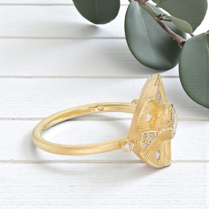 Victorian style diamond ring featuring an engraved talisman design with intricate handcrafted detailing, antique inspired metalwork, and a timeless elegant engagement ring aesthetic with vintage fine jewelry craftsmanship.